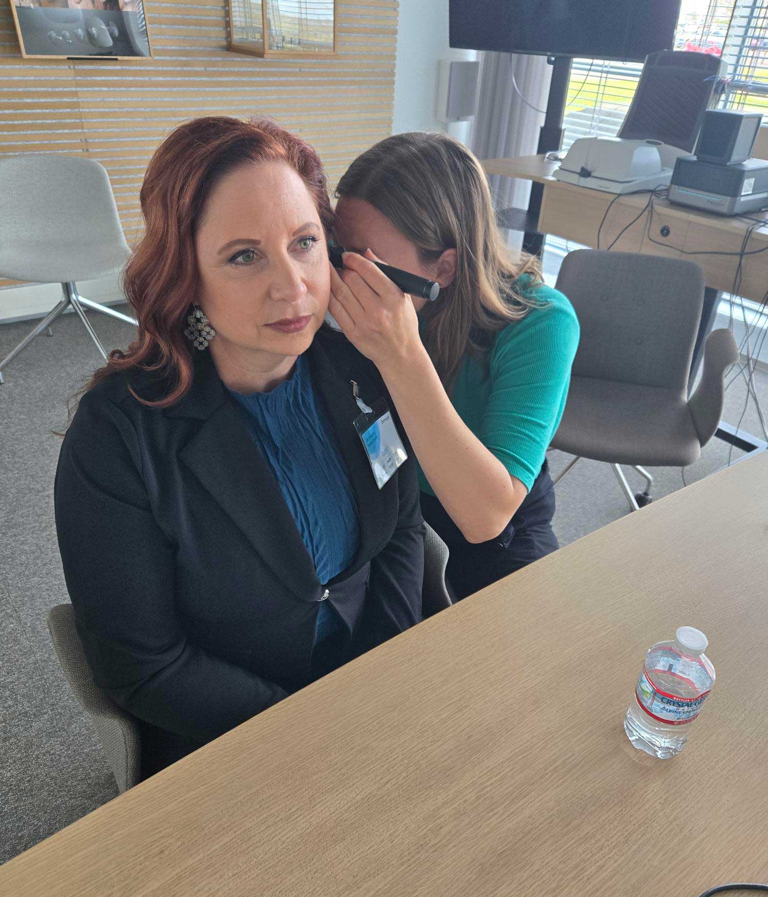 Dr. Judy Olson being fitted with Oticon Zeal hearing aids, April 2025